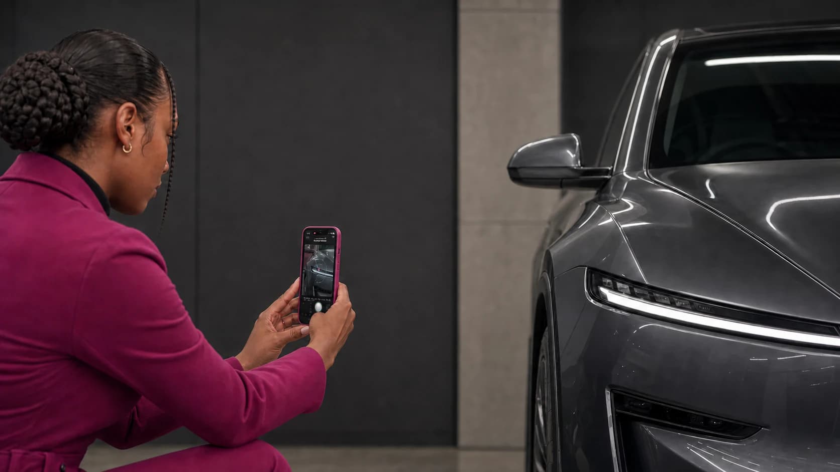 Dealership employee using Halo guided capture beside the front quarter of a vehicle.