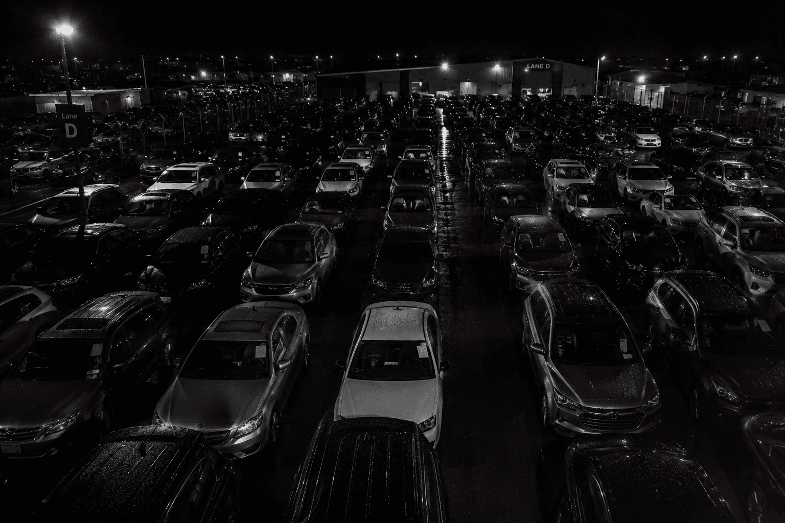Rows of vehicles in a dense night lot environment showing operational vehicle capture complexity.
