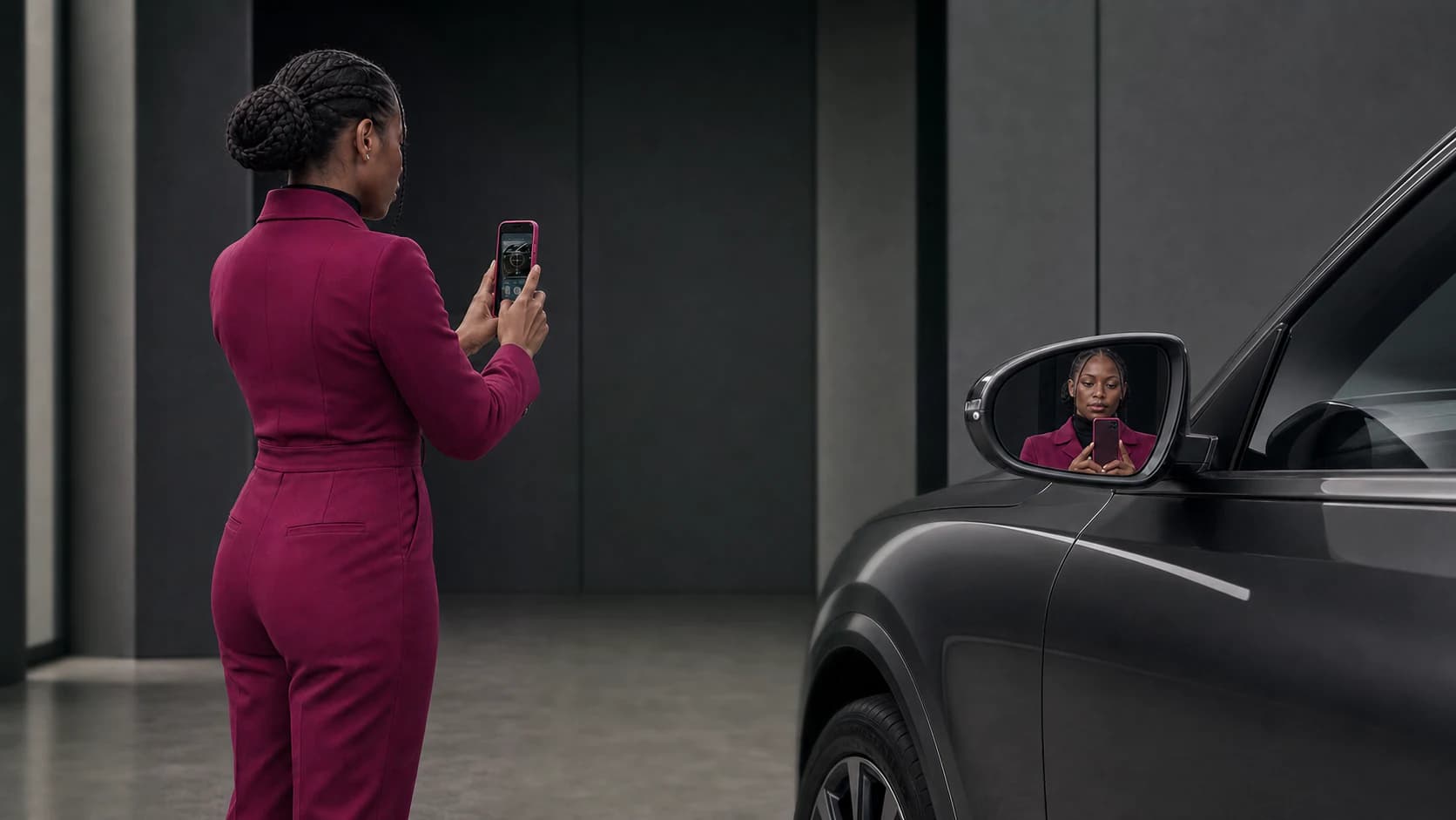 Person using Halo Compass beside a vehicle side mirror during a guided dealership observation.