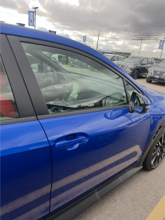 Front-door close-range capture of a blue WRX continuing the guided side sequence.